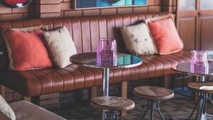 A cozy seating area with a leather couch, round tables, and a guitar hanging on the wall. - Vibin' Fun House 400meters (5 min walk) to D'Albora Marinas.
Outdoor Spa
 (Nelson Bay)