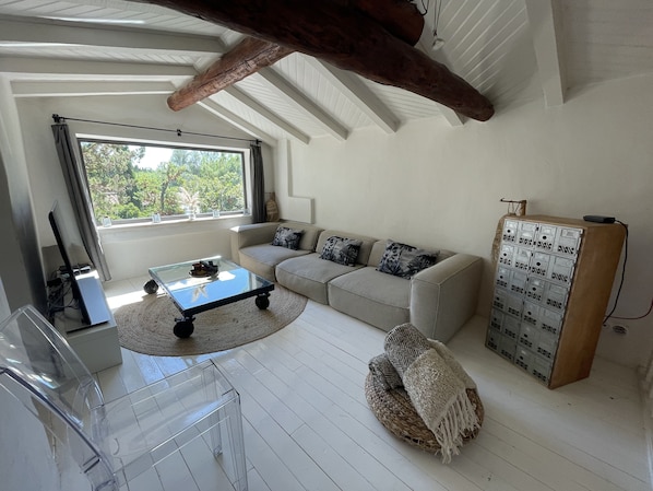 A modern living room with a sofa, coffee table, and a unique storage unit.