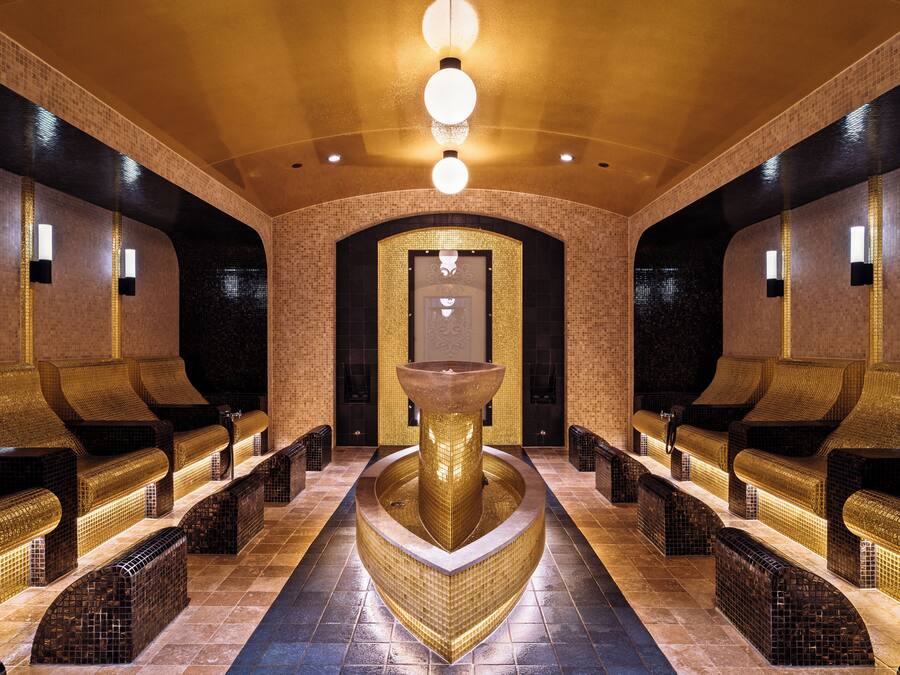 A spa area with seating and a central fountain.