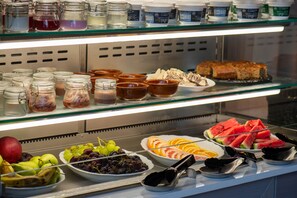 A buffet with various food items including fruits, desserts, and beverages. - MY WAY HOTEL & EVENTS (Patras)