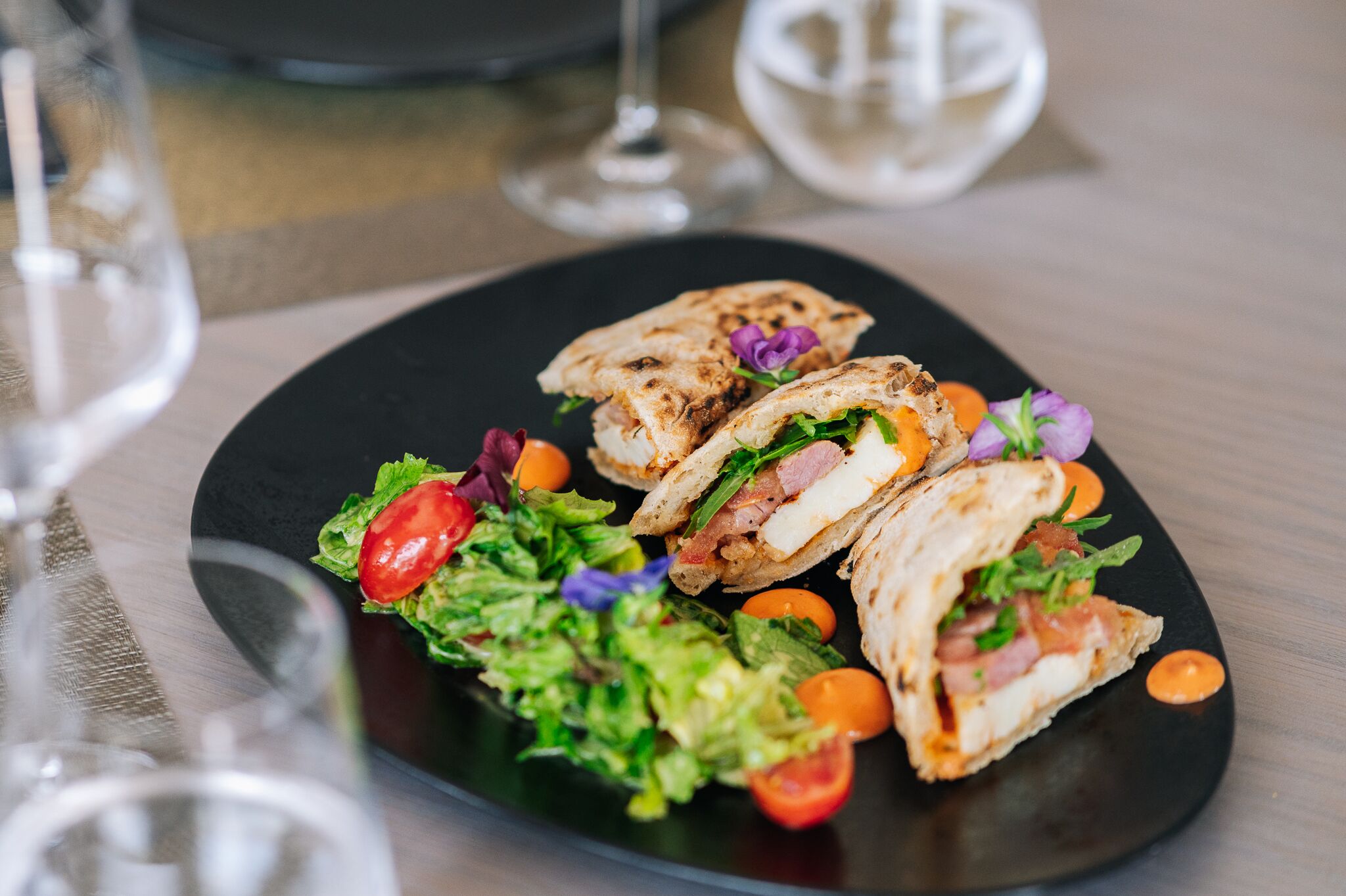 A plate with a sandwich and a salad.