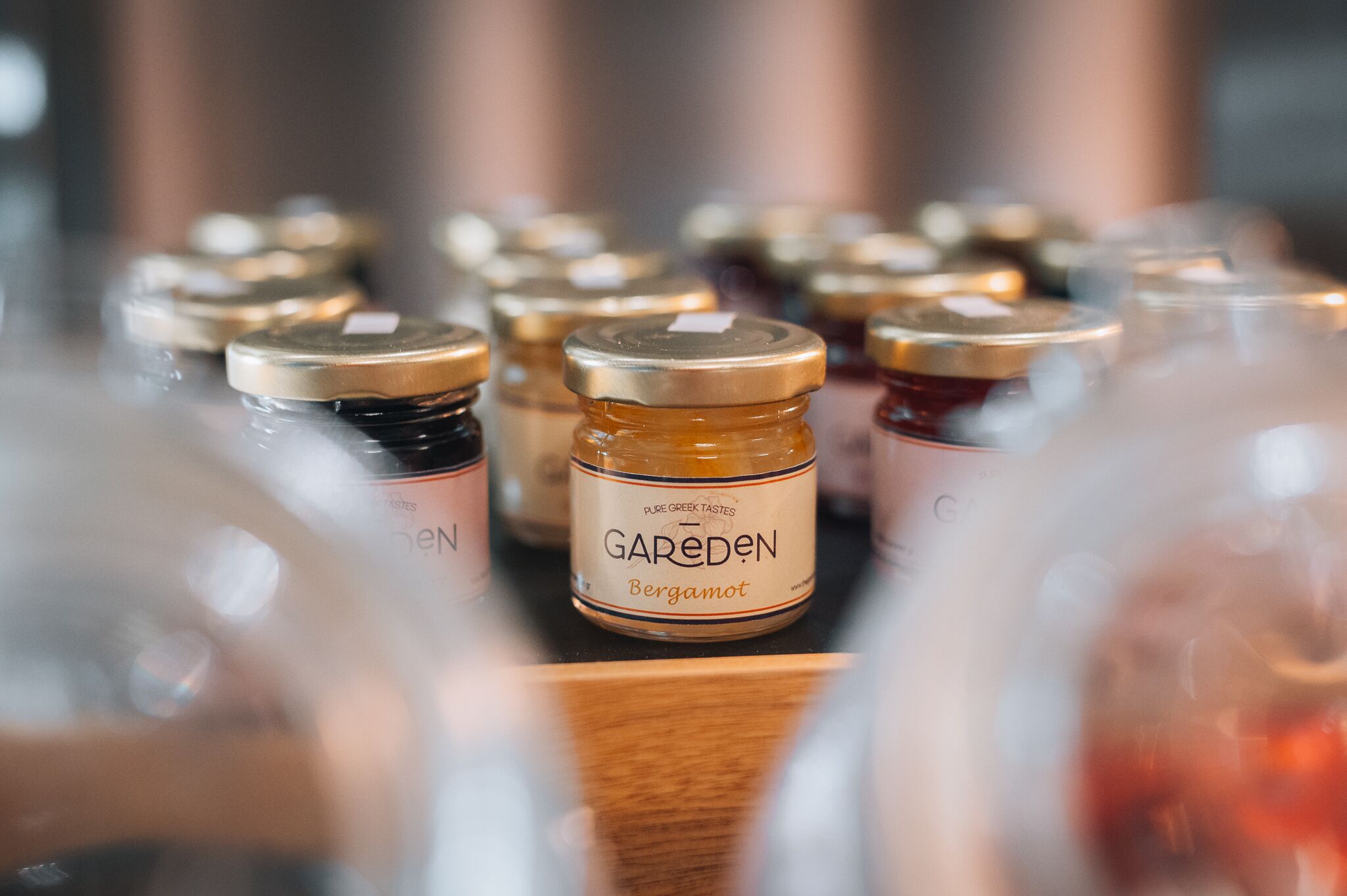 A collection of jars with labels, some with gold caps and others with silver.