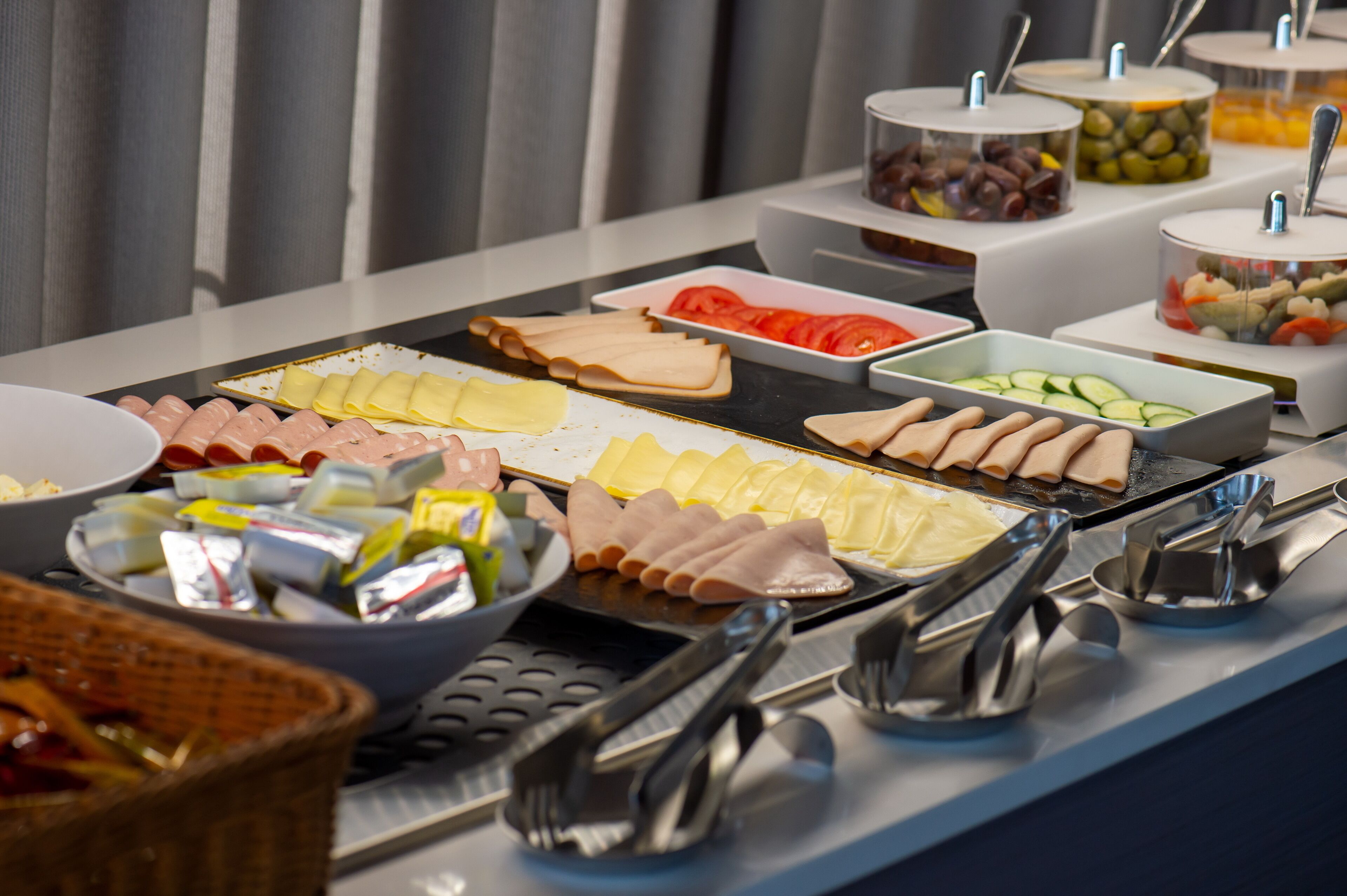 A buffet with various food items and condiments.