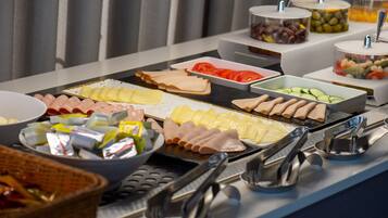 A buffet with various food items and condiments.