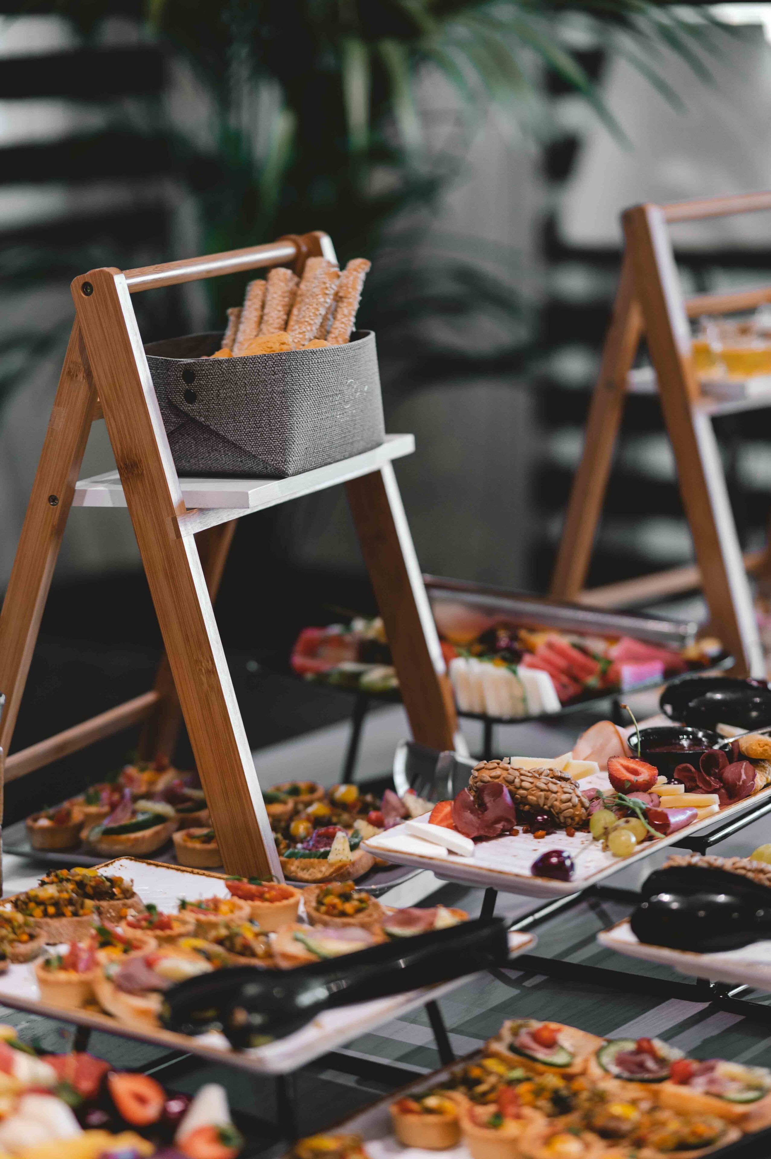 A buffet with various food items displayed on trays and stands.