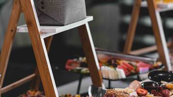 A buffet with various food items displayed on trays and stands.