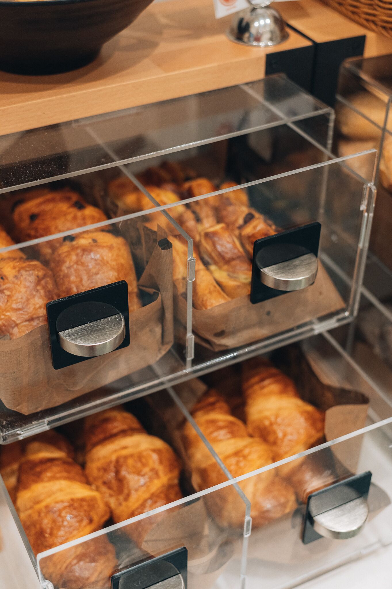 A bakery display case with multiple compartments containing baked goods.