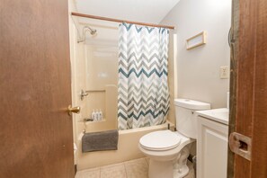 A bathroom with a shower, toilet, and sink. - A-Frame Cabin on Table Rock Lake- by SDC! (Branson)