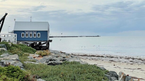 A blue building labeled 'Busse-Lot Jetty' on a rocky beach with a pier in the background. - Getaway to Cabin 49- this charming, cute cabin located in the Geographe Holiday Park (Broadwater)