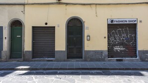 A building with three doors, one of which is labeled "Fashion Shop." - Pinocchio by Mmega (Florence)