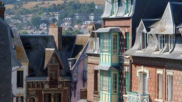 A street view with traditional European architecture, including buildings with steep roofs and decorative elements.