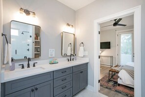 Bathtub, hair dryer, towels, shampoo