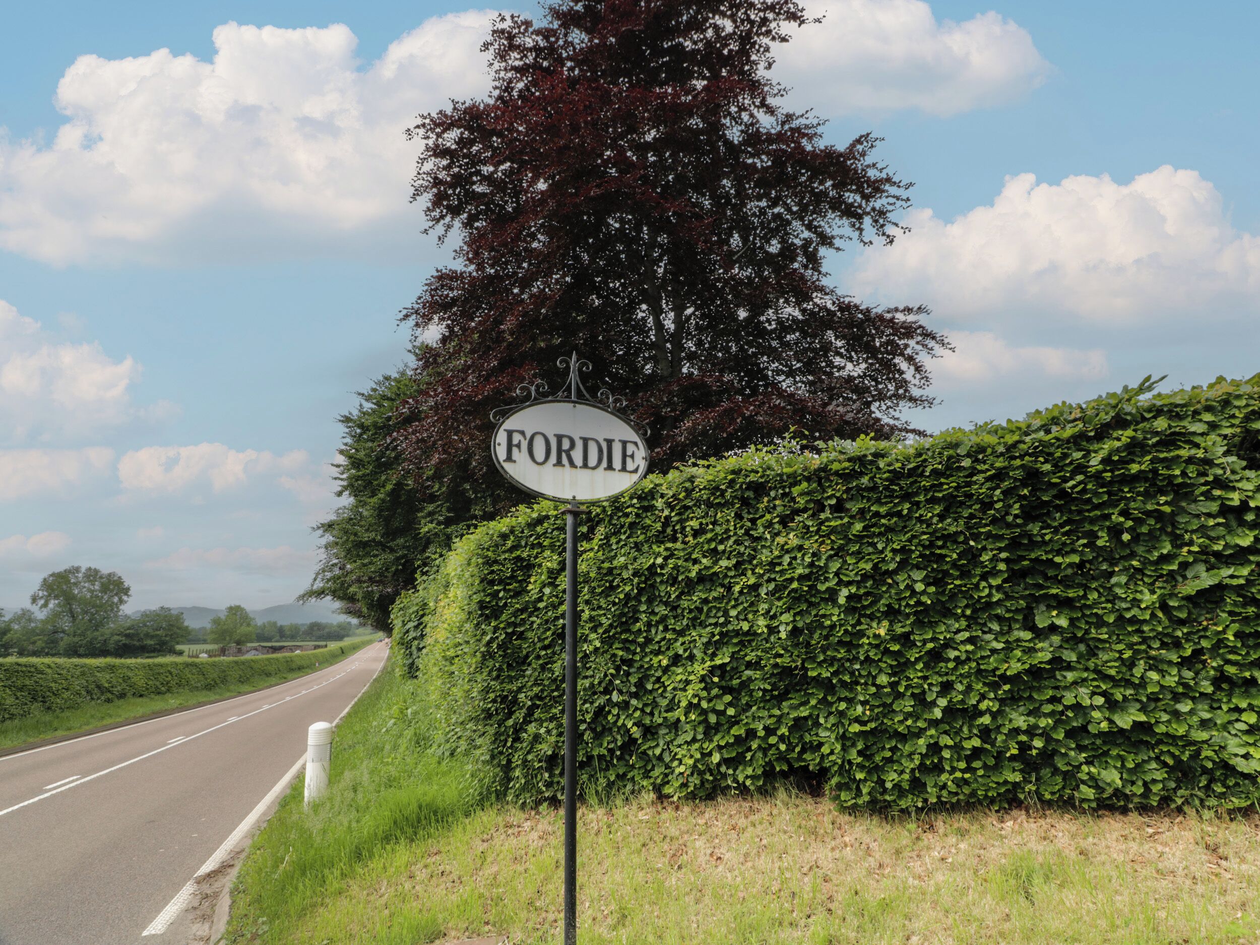 A road sign with the name 'FORDIE' on a clear day.