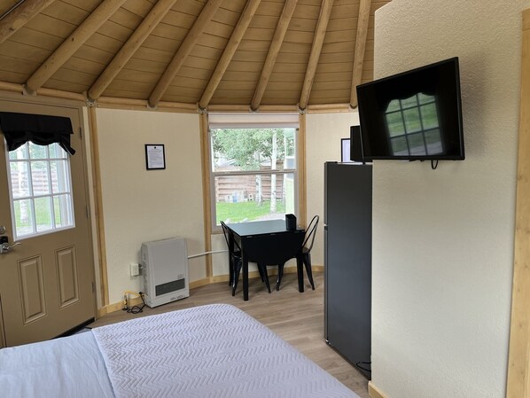 Relax in this cozy retreat with a comfortable bed, dining area, and flat-screen TV.