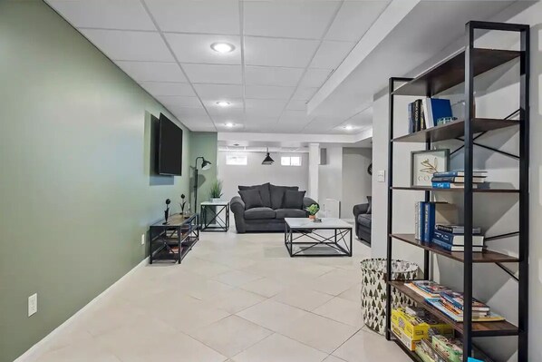 A modern living room with a sofa, coffee table, and bookshelf.