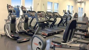 A gym with multiple treadmills, ellipticals, and weight machines. - Villa Vista by VIAC - 2 Story w/ 3Bdrms & Golf View (Doral)