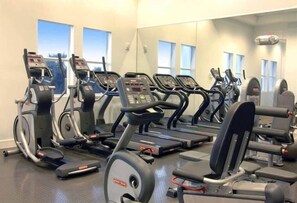 A gym with multiple treadmills, ellipticals, and weight machines. - Villa Vista by VIAC - 2 Story w/ 3Bdrms & Golf View (Doral)