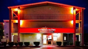 A hotel with a red facade and a sign reading "extend suites". - Rodeway Inn Albuquerque West (Albuquerque)