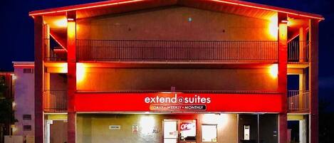 A hotel with a red facade and a sign reading "extend suites".