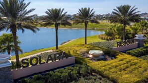 A resort named Solara with a view of a lake, palm trees, and a well-maintained lawn. - 1798 TP - 4BR Luxury Solara Retreat Pool Disney (Kissimmee)