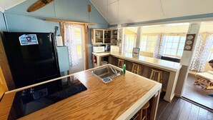 A compact kitchen with a black refrigerator, wooden countertop, and a small sink. - Lakefront Cabin w/ Dock & Kayaks, Perfect Summer Stay
Rustic Nautic - Cabin 9 (South Haven)