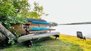A small cabin with a dock extending into a lake, surrounded by greenery. - Lakefront Cabin w/ Dock & Kayaks, Perfect Summer Stay
Rustic Nautic - Cabin 9 (South Haven)
