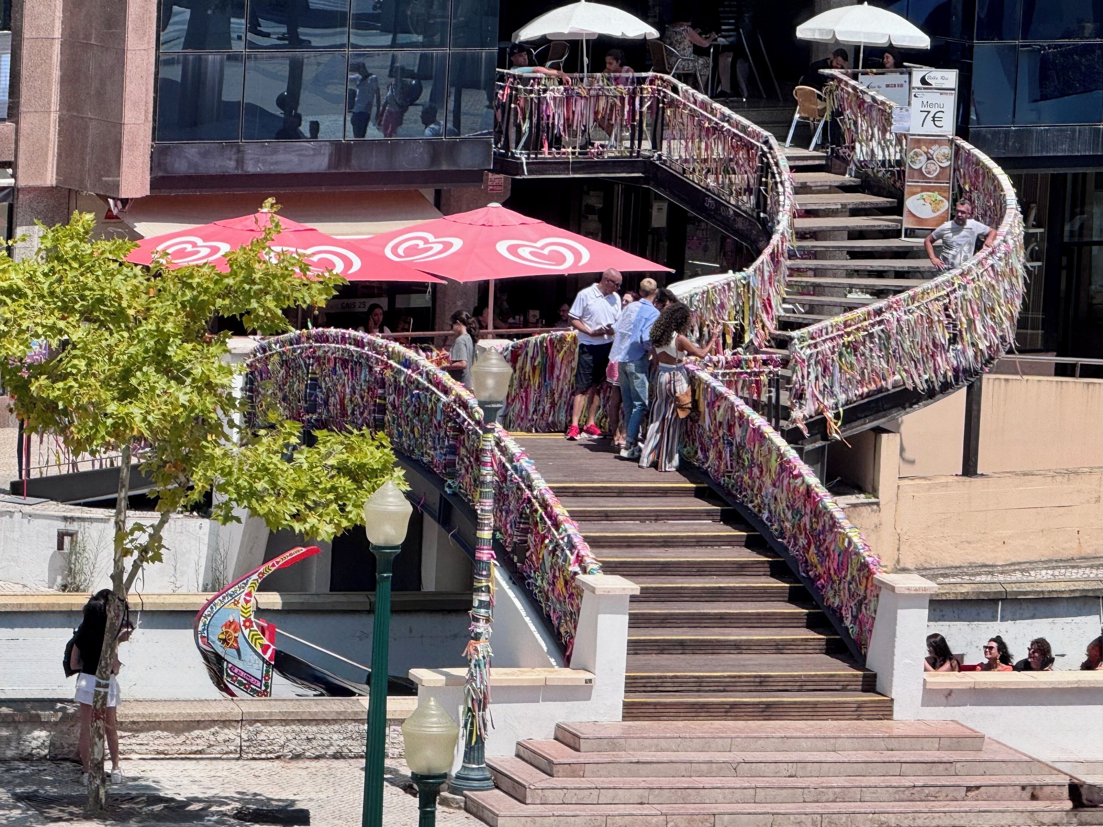 A spiral staircase with colorful decorations, leading to an upper level.