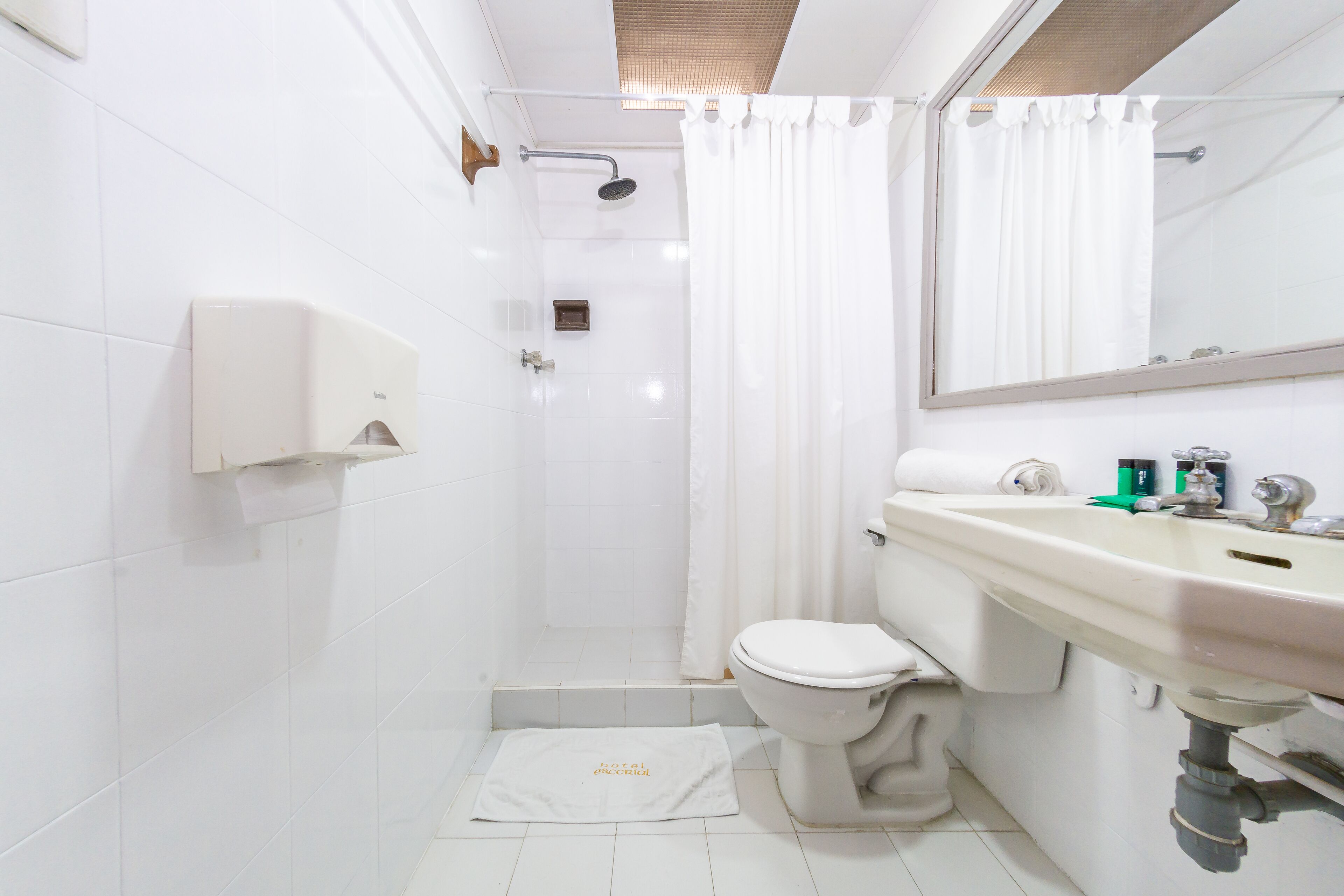 A modern bathroom with a toilet, sink, and shower area.