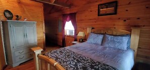 Cozy bedroom with a single bed, nightstand, and dresser, offering a peaceful retreat.