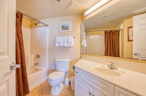 A bathroom with a bathtub, toilet, and sink. - Winter Specials! 2BD Ocean View-Lazy River/Hot Tubs/Indoor Pool (North Myrtle Beach)