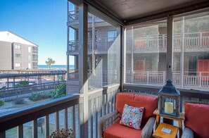 Enjoy the ocean view from this balcony with a seating area and lantern.