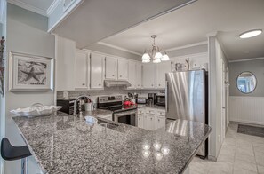 Enjoy cooking in this well-equipped kitchen with an oven, microwave, and refrigerator.