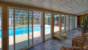 A covered patio area with a pool, sliding glass doors, and outdoor furniture. - 4BD Beach House-Private Pool-3 Min Walk 2Beach (North Myrtle Beach)