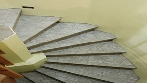 A spiral staircase with a textured floor, leading upwards against a plain wall. - Apartment with bath, tv, ac and a view to die for (Estate Bovoni)