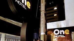 A hotel sign with the name 'One Hotel' prominently displayed.