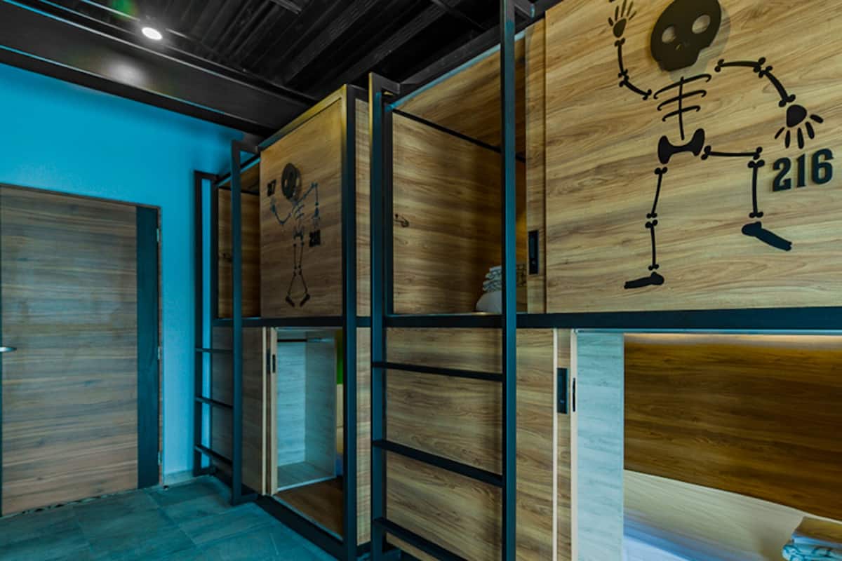 A modern interior with wooden panel walls, metal shelving, and a blue accent wall.