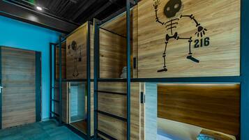 A modern interior with wooden panel walls, metal shelving, and a blue accent wall.