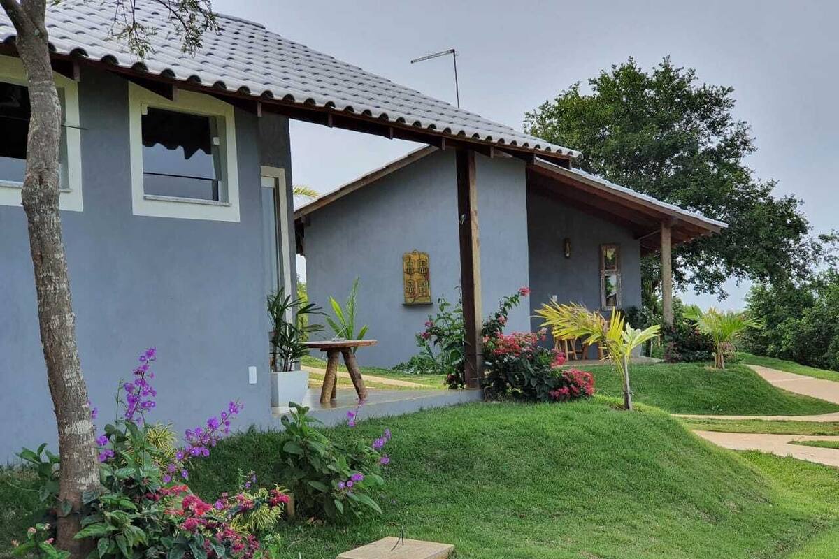 A two-story house with a grey exterior and a tiled roof.