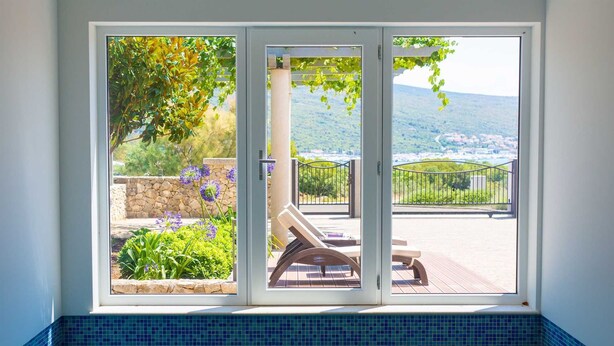 A pool area with a view of a garden and a distant landscape. - Apartment ROYAL 1 with pool and jacuzzi (Kornić)