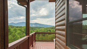 A wooden deck with a view of a mountainous landscape. - Mountain View Cabin|Hot Tub|Fenced Yard for Pets (Mill Spring)