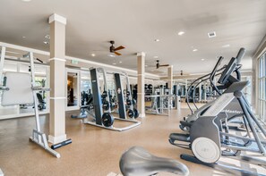 A gym with treadmills, weight machines, and free weights.