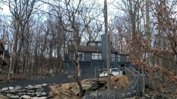 A stone pathway leading to a gated area with a metal fence and a staircase. - Poconos Top Rated Resort - Saw Creek Estates (Bushkill)
