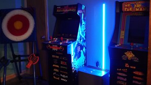 A room with arcade machines, a dartboard, and a target on the wall. - Poconos Top Rated Resort - Saw Creek Estates (Bushkill)