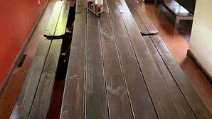 A wooden bench with a metal frame, a wooden table, and a bench in a hallway. - Poconos Top Rated Resort - Saw Creek Estates (Bushkill)