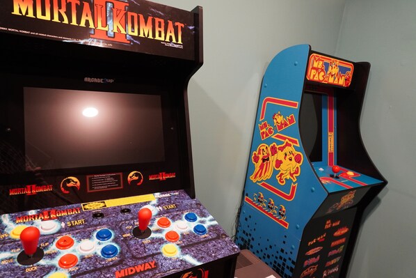 Two arcade machines, one labeled 'Mortal Kombat' and the other 'Pac-Man.' - Poconos Top Rated Resort - Saw Creek Estates (Bushkill)