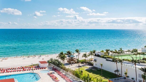 A resort with a pool, beach, and ocean view. - Oceanfront renovated condo on the beach - amazing ocean view (Sunny Isles Beach)