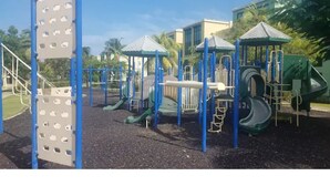 A playground with climbing structures, slides, and a covered area. - 5 pools, Amazing Rooftop Views , Beach (Vieques)