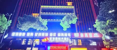 A building with illuminated signage and a prominent entrance.