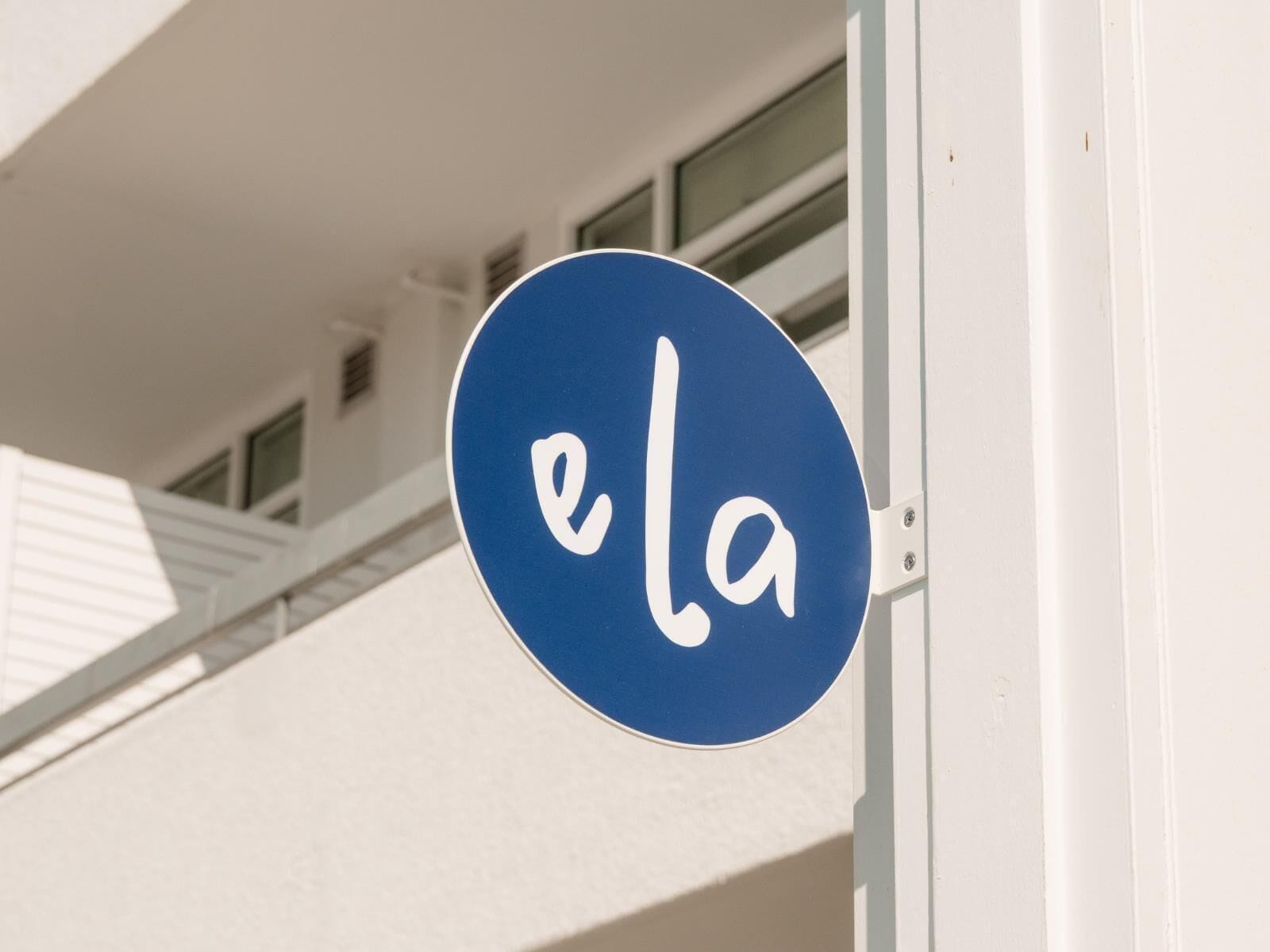 A blue sign with the word "ela" on it.