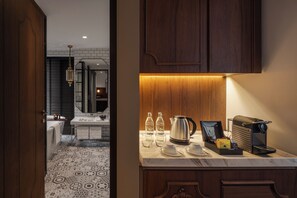 A modern bathroom with a large mirror, a sink, and a shower area.